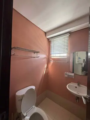 a bathroom with a toilet and a sink at East Bay Residences Condo Unit in Muntinlupa in Manila