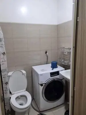 a small bathroom with a toilet and a sink at Staycation in Alabang Branch B in Manila