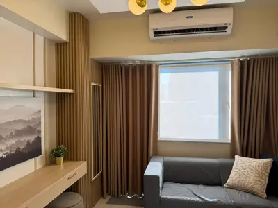 a living room with a couch and a window at Shore 3 Residence Aesthetic 1 BR in Manila