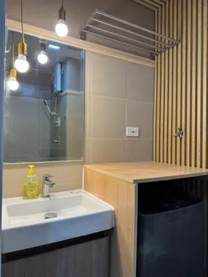a bathroom with a sink and a counter top at Shore 3 Residence Aesthetic 1 BR in Manila