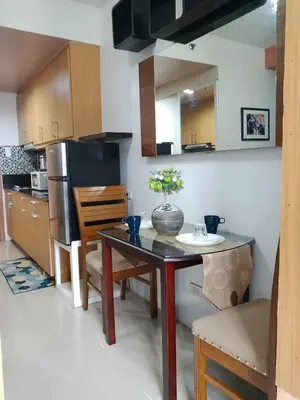 a kitchen with a table and chairs and a refrigerator at 503-1queen bed 1-pull out 1-sofa bed 1- extra matressedsa view in Manila