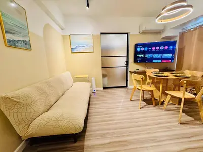 a living room with a couch and a table at Cozy Vibes Retreat in Makati in Manila