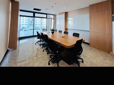 a conference room with a large wooden table and chairs at Cozy Vibes Retreat in Makati in Manila