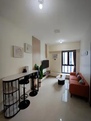 a living room with a couch and a table at 1BR near Podium or Marco Polo in Manila