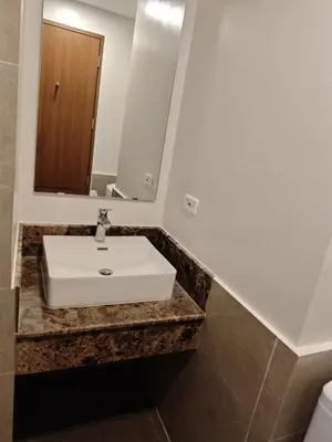 a bathroom with a sink and a mirror at 1BR near Podium or Marco Polo in Manila