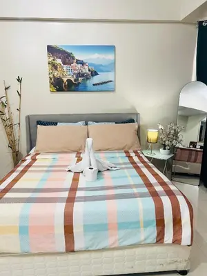 a bedroom with a bed with two teddy bears on it at One Tree villas - Hyuna Place, Across NAIA T3 in Manila