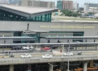 a building with cars on a highway in front at One Tree villas - Hyuna Place, Across NAIA T3 in Manila