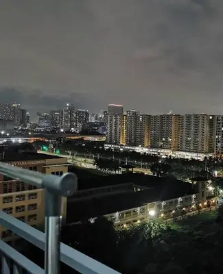 a view of a city at night with buildings at Mao condotel shore 3 residence in Manila