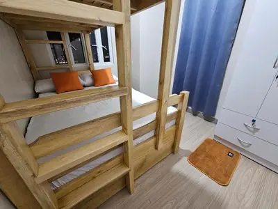 a room with a bunk bed with orange pillows at Suntrus,t Solana Condominium - Ermita, Manila - SM Manila in Manila