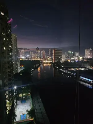 a view of a city at night with a river at Suntrus,t Solana Condominium - Ermita, Manila - SM Manila in Manila