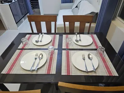 a black table with plates and silverware on it at Suntrus,t Solana Condominium - Ermita, Manila - SM Manila in Manila