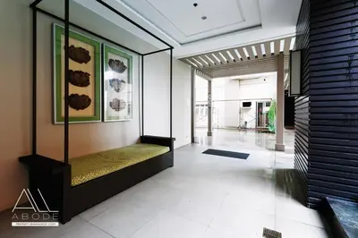 a hallway of a house with a couch in it at Modern Zen 1-bedroom with balcony in Manila