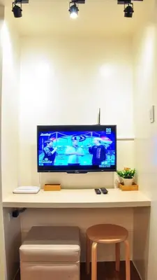 a desk with a television on top of a table at Modern Zen 1-bedroom with balcony in Manila