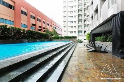a swimming pool in the middle of a building at Modern Zen 1-bedroom with balcony in Manila