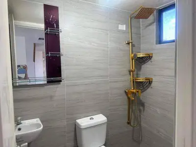 a bathroom with a toilet and a sink at Condo apartment in Manila