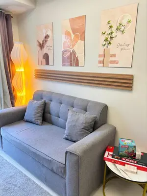 a living room with a couch and a table at Meteoria Staycation in Manila