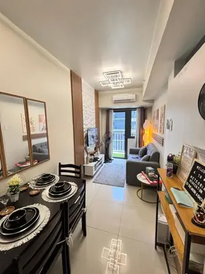 a kitchen and living room with a stove at Meteoria Staycation in Manila