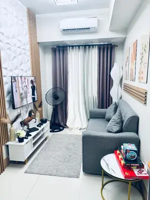 a living room with a couch and a table at Meteoria Staycation in Manila