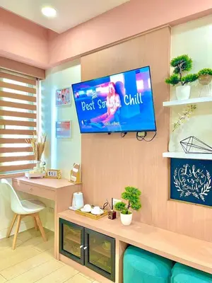 a room with a tv hanging on a wall at Elegant Suite with Balcony l Free wifi and netflix I Across NAIA T3 Airport in Manila
