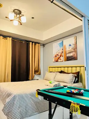 a bedroom with a pool table in front of a bed at Azure Beach View with Balcony PS4 Billiards in Manila