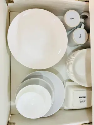 a drawer filled with white plates and utensils at Azure Beach View with Balcony PS4 Billiards in Manila