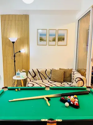 a living room with a pool table and a couch at Azure Beach View with Balcony PS4 Billiards in Manila