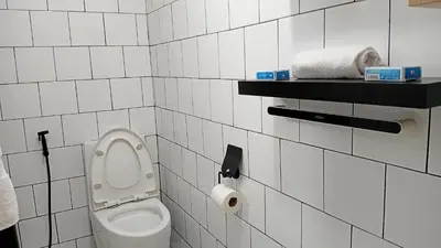 a bathroom with a toilet and a roll of toilet paper at BahayMandaragat2 in Manila