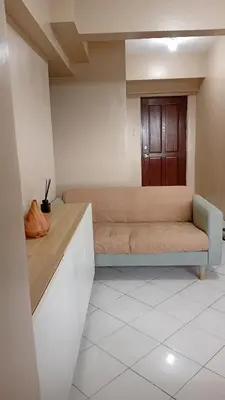 a room with a couch and a wooden door at BahayMandaragat2 in Manila