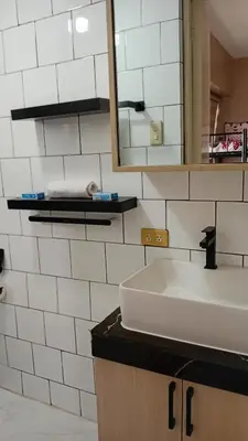 a bathroom with a sink and a mirror at BahayMandaragat2 in Manila