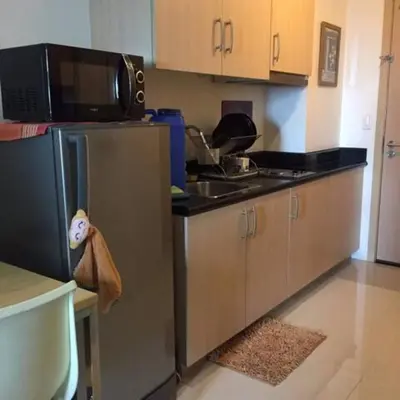 a kitchen with a stainless steel refrigerator and a microwave at Bernie and Adel's Property Rental in Manila