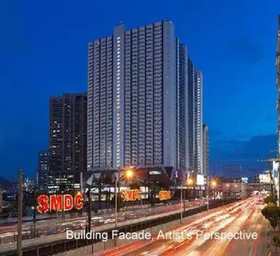 a large tall building in a city at night at Bernie and Adel's Property Rental in Manila