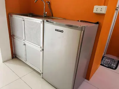 a refrigerator in a kitchen with a sink at OYO 1157 Kegama Residences 1 in Cavite