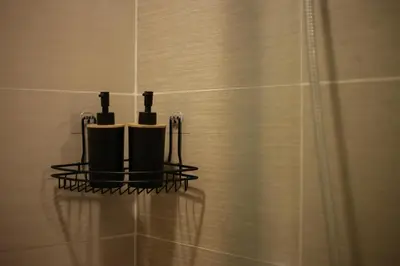 a bathroom with a rack with three toothbrushes at Venice Grand Canal View Condo in Manila