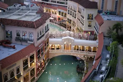 an overhead view of a building with a bridge over water at Venice Grand Canal View Condo in Manila
