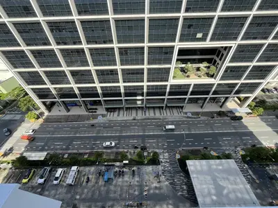 an aerial view of a parking lot in front of a building at Cozy 2 Beds Near Mall of Asia in Manila