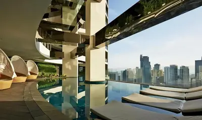 a building with a pool with a view of a city at The Gramercy Residences in Manila