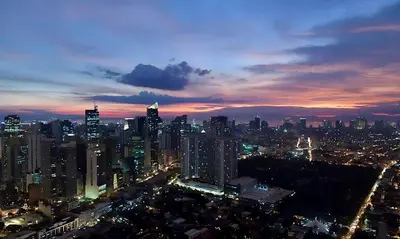 a view of a city at night at The Gramercy Residences in Manila