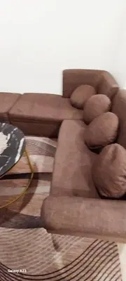 a brown couch sitting in a living room at Alabang homely in Manila