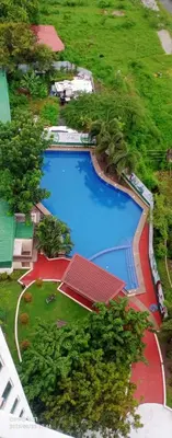 an overhead view of a large swimming pool with trees at Alabang homely in Manila