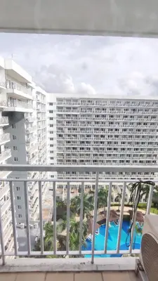 a balcony with a view of a large building at Condo Staycation Shell Residence in Manila