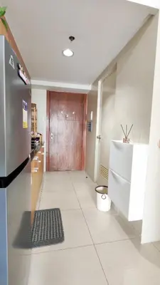 a kitchen with a door and a tile floor at Condo Staycation Shell Residence in Manila