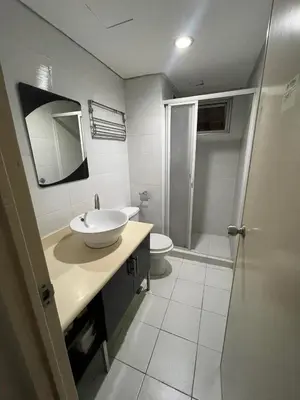 a bathroom with a sink and a toilet at Studio Condominium by Koteniko in Manila