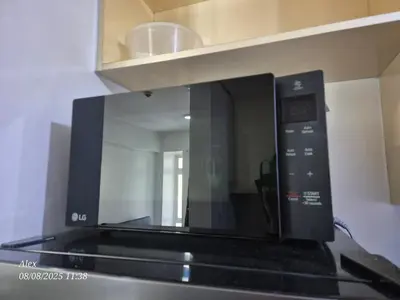 a microwave oven sitting on top of a stove at 1BR Condo at NAIA and Newport Casino Area in Manila