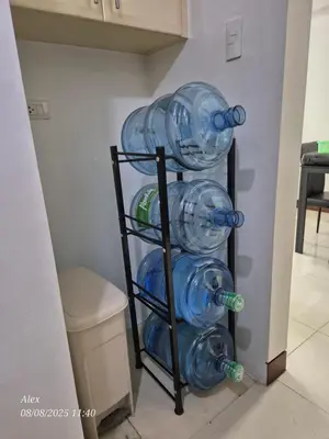 a rack of glass water bottles in a room at 1BR Condo at NAIA and Newport Casino Area in Manila