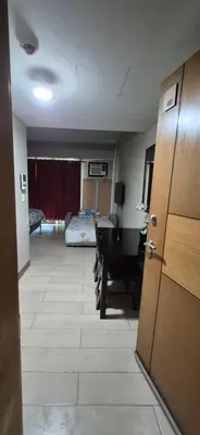 a hallway with a room with a desk and a bedroom at Affordable Rooms by Rqui Near Airports in Manila