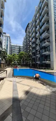 a pig sitting next to a swimming pool in a city at Affordable Rooms by Rqui Near Airports in Manila