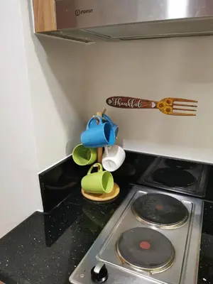 a toy kitchen with a stove top with a spatula at Mall of Asia condotel shore 3 in Manila