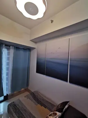 a bedroom with a large wall mural of a ocean at Mall of Asia condotel shore 3 in Manila