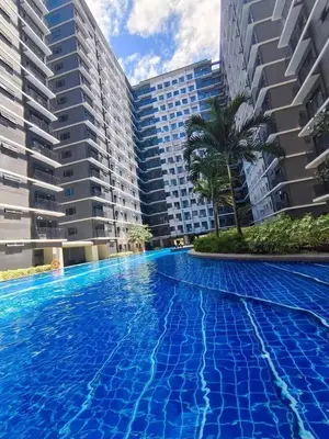 a swimming pool in front of some buildings at Mall of Asia condotel shore 3 in Manila