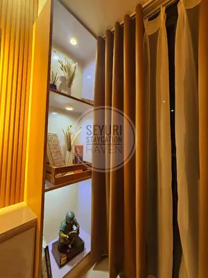 a room with brown curtains on a shelf at Seyuri Staycation Haven in Manila